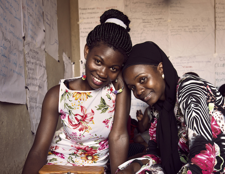 Two young African women smiling