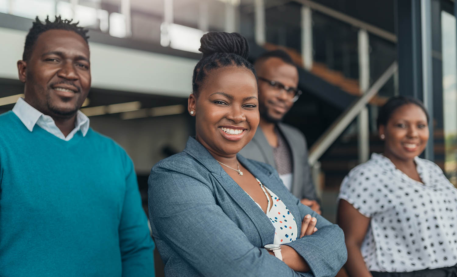 Group Of Black Men And Women In Smart Dress Smiling At Camera