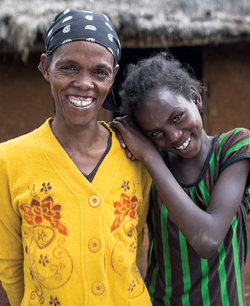 Black Woman And Girl Smiling, The Girl Leans Her Head On The Woman's Shoulder