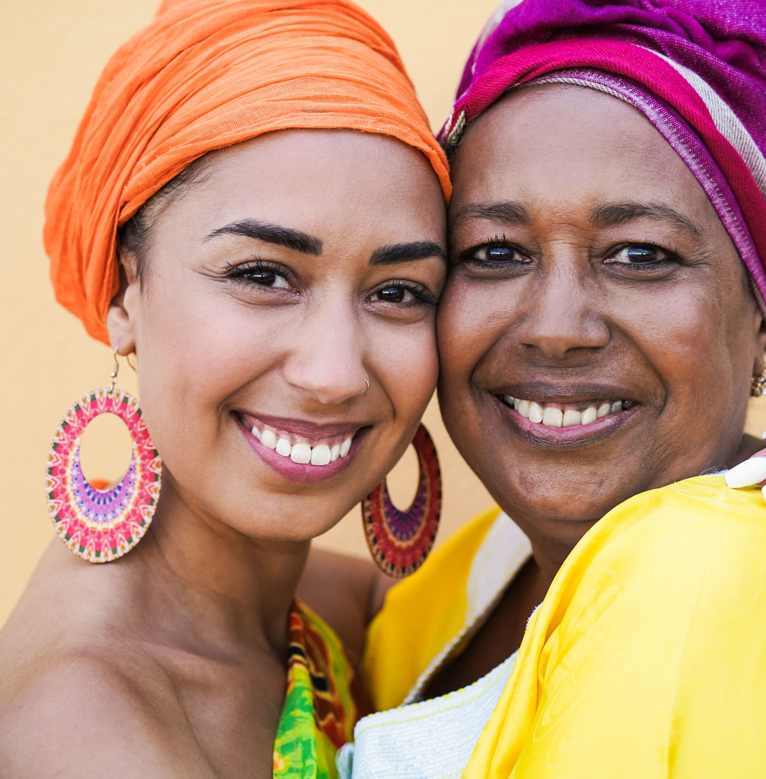 Portrait of black mother and daughter smiling and hugging