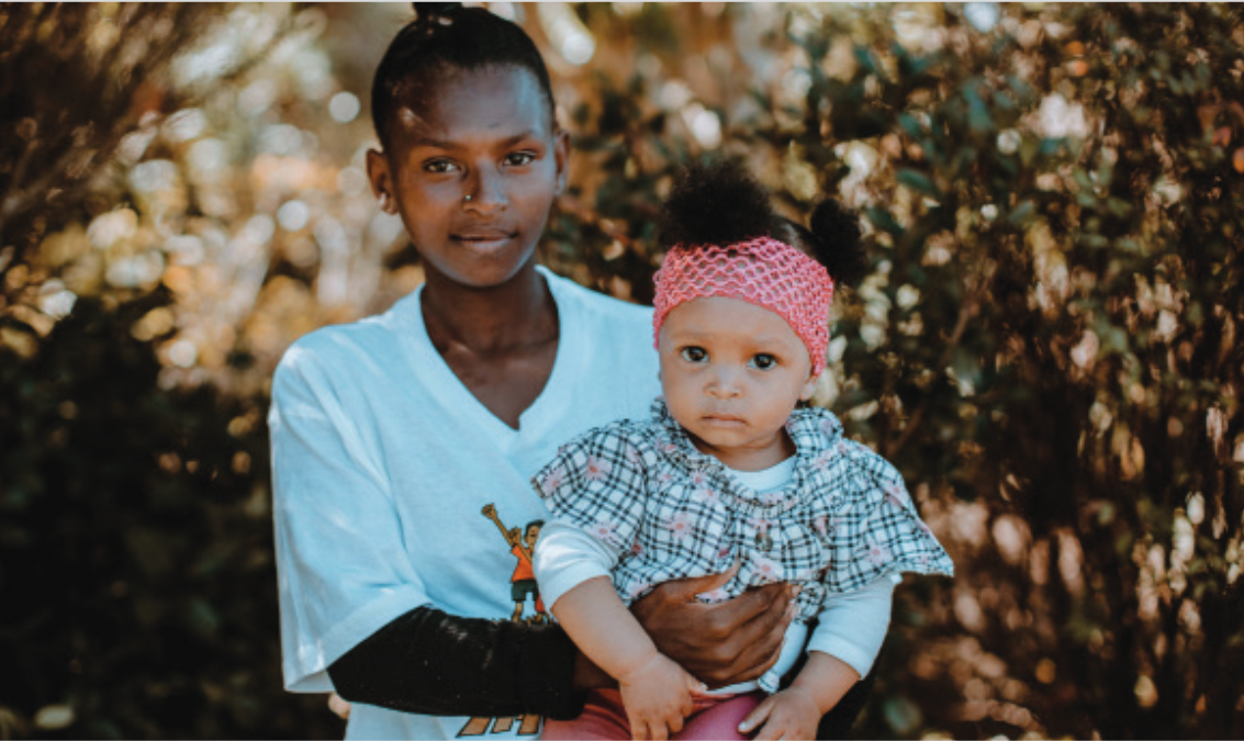 A Black Woman Is Carrying A Baby Girl.